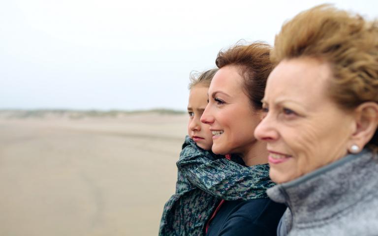 Grandmother, mother and daughter at the beach