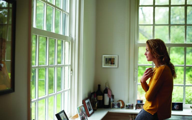 Woman looking outside window