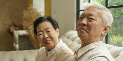 Senior Asian couple sitting on a couch